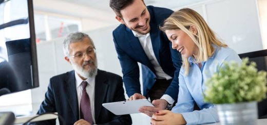 Smiling,Young,Manager,Helping,Senior,Worker,With,Funny,Computer,Work